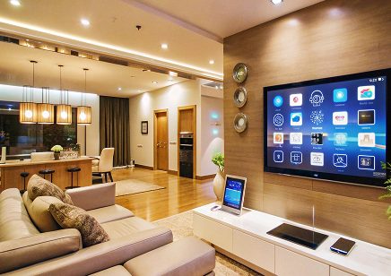 Modern living room with a large wall-mounted smart TV and a comfortable sectional sofa